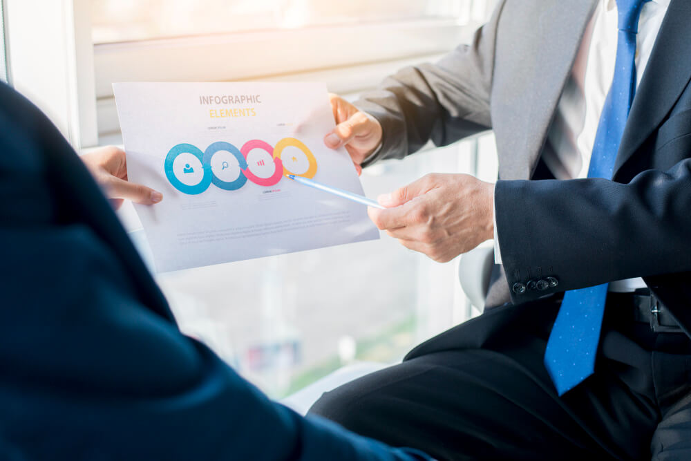 two-businesspeople-holding-infographic-elements-sheet (1) (1)